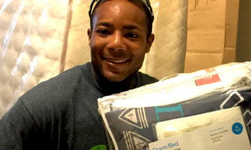 TGCP's Sweeter Dreams volunteer delivering a new bed, bedding to Wake County children