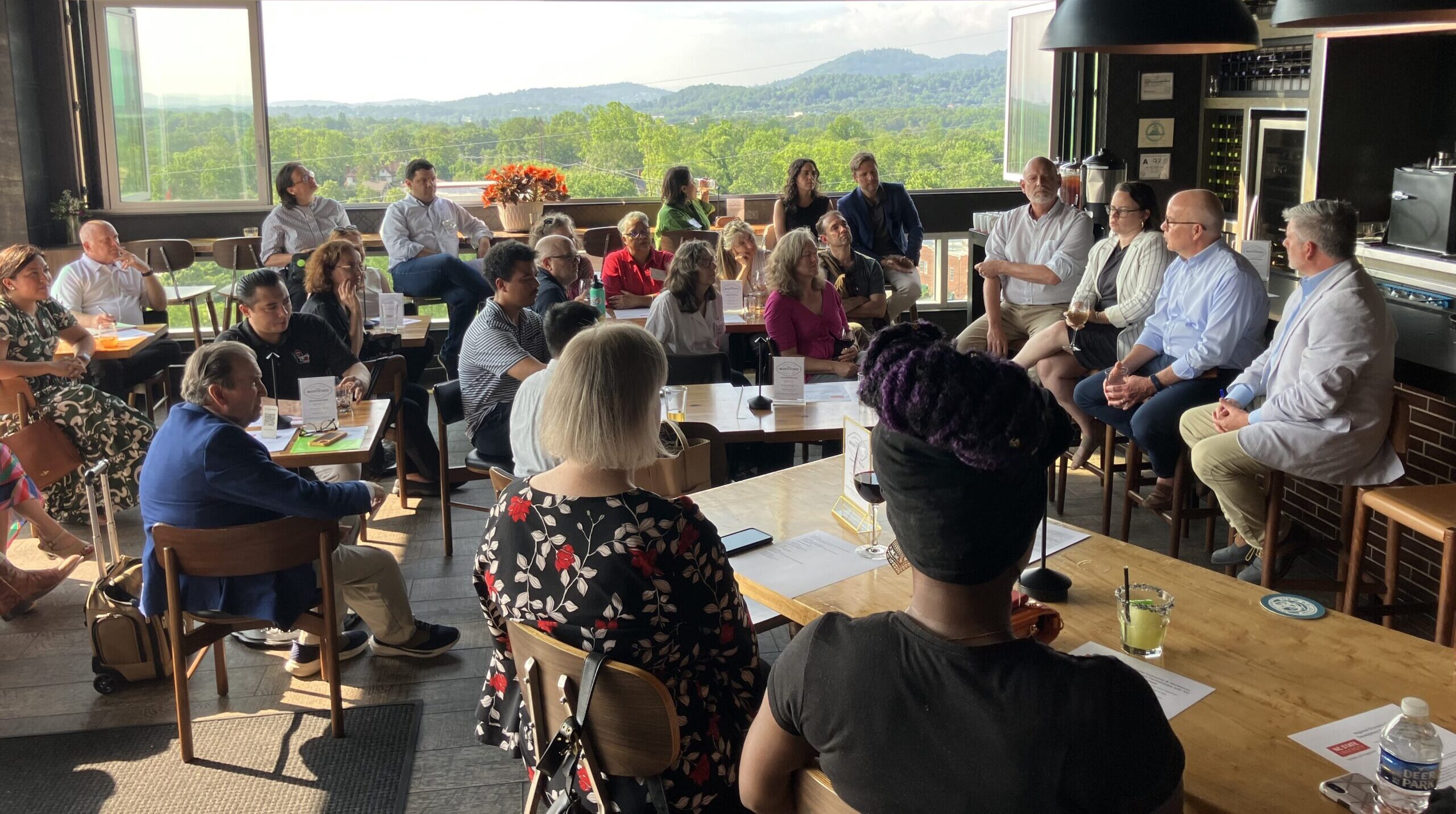 A group of people listening to a talk in a restaurant